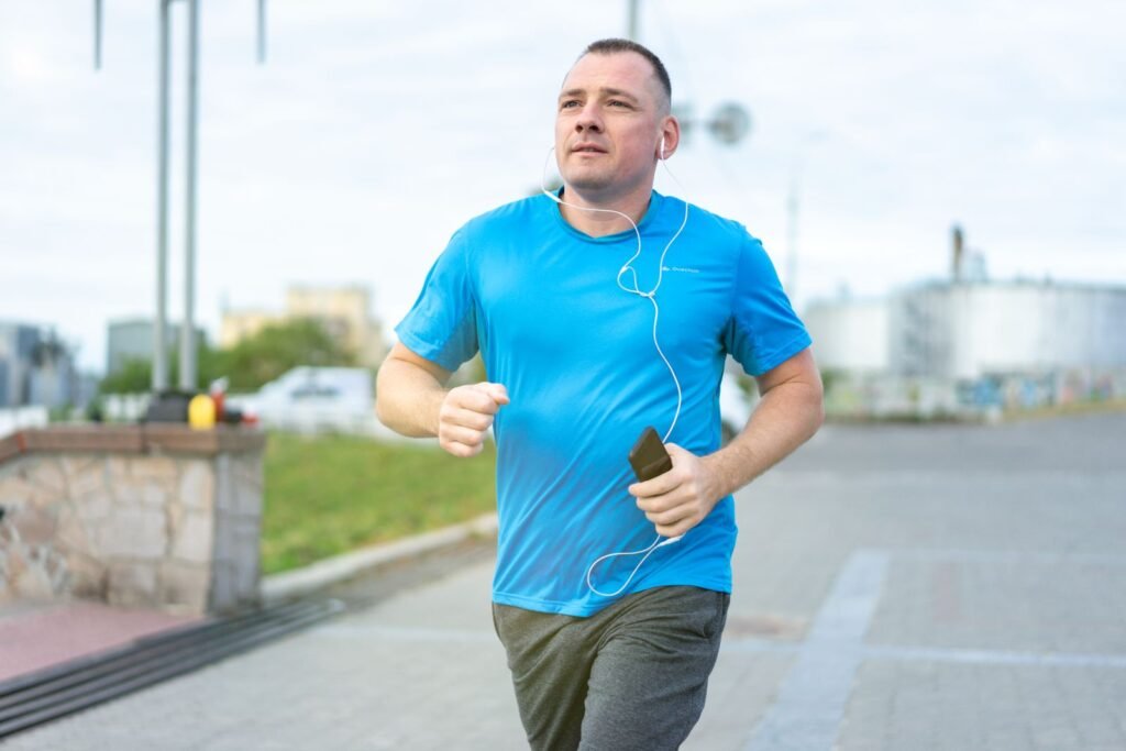 Man jogging outdoors while tracking his run