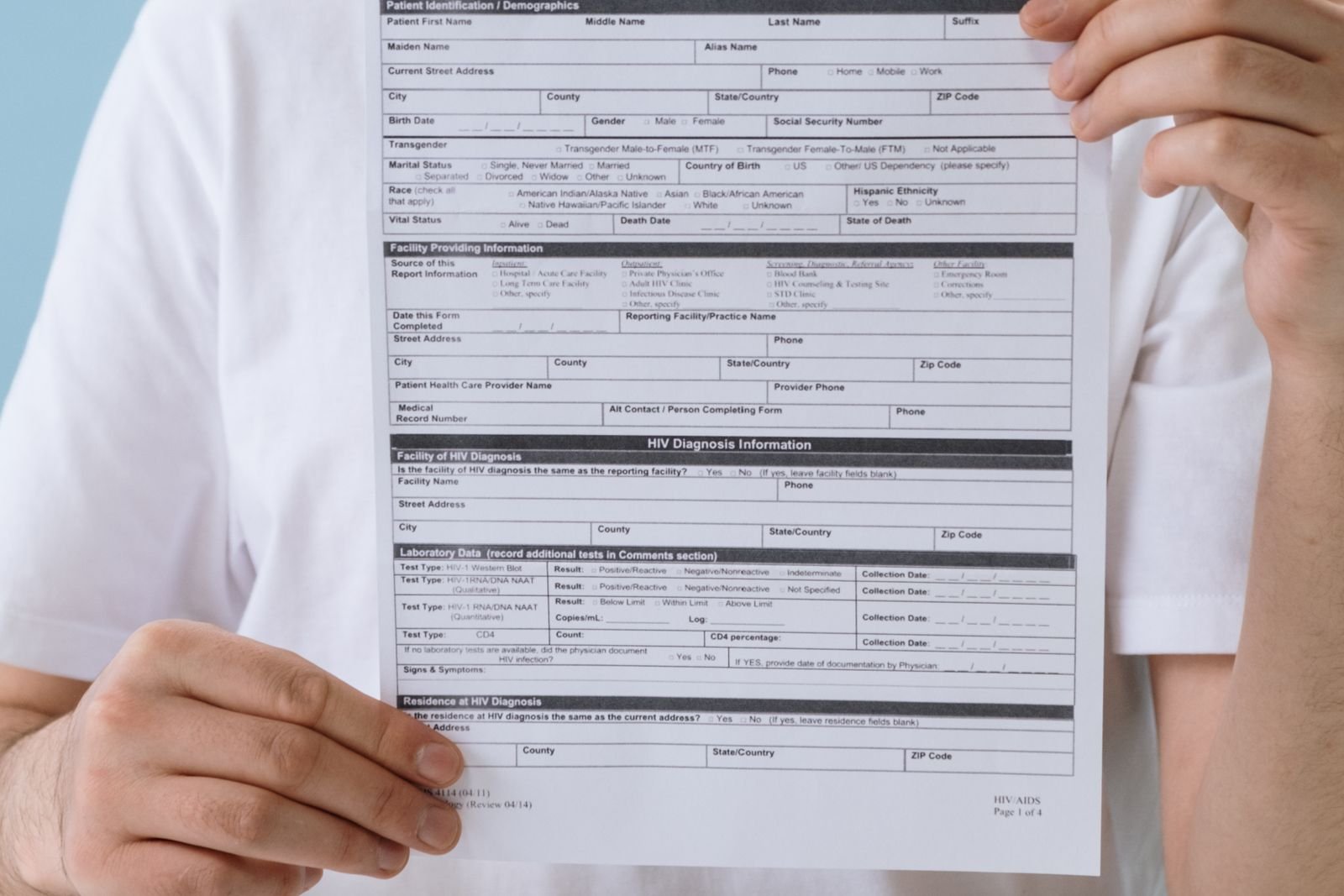 Hands holding a blank medical record form