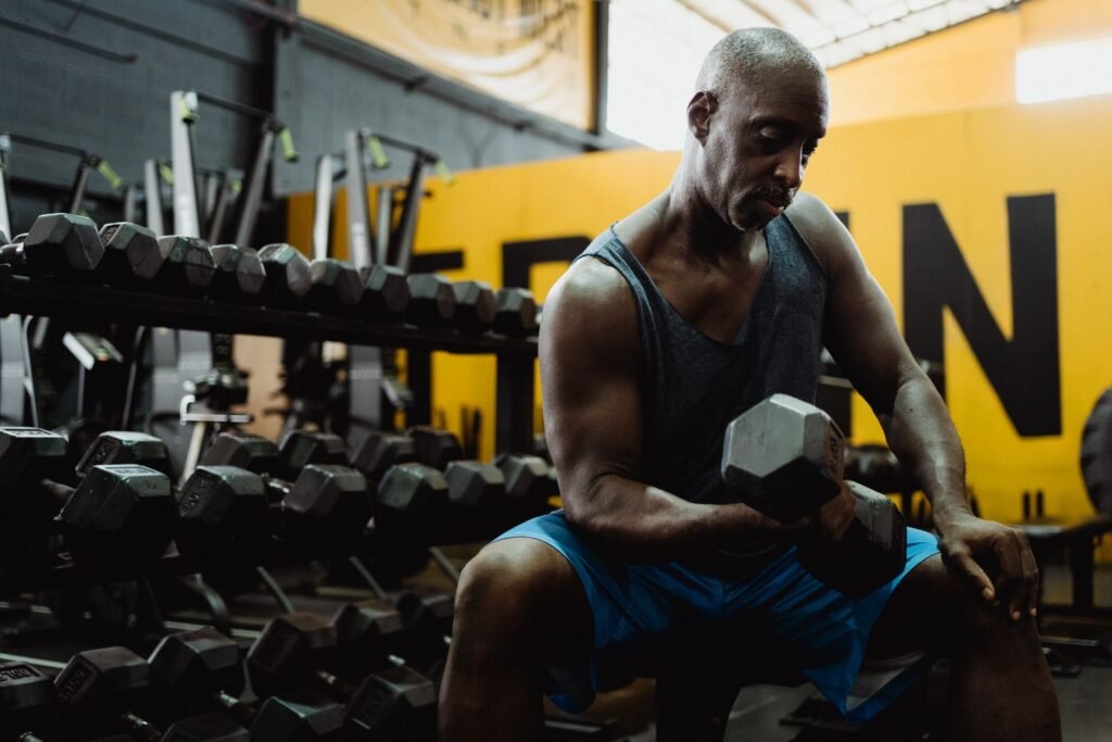 Man lifting weights in a gym, building strength