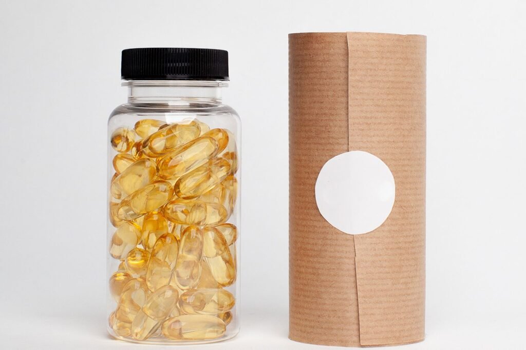 Clear bottle filled with golden softgel capsules