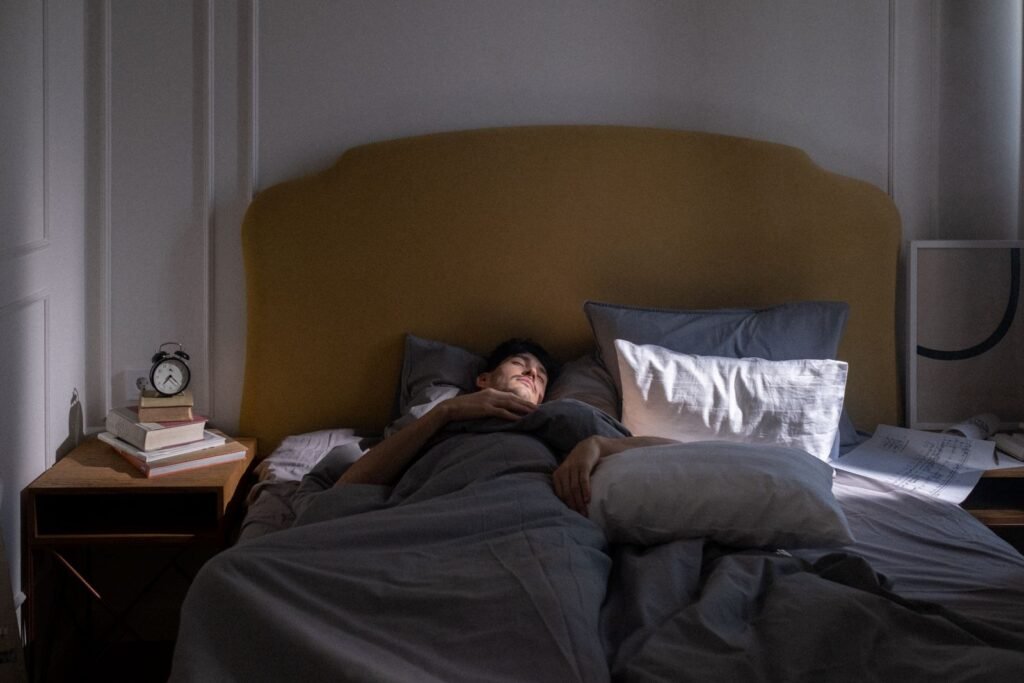 Man in bed with soft morning sunlight through the window