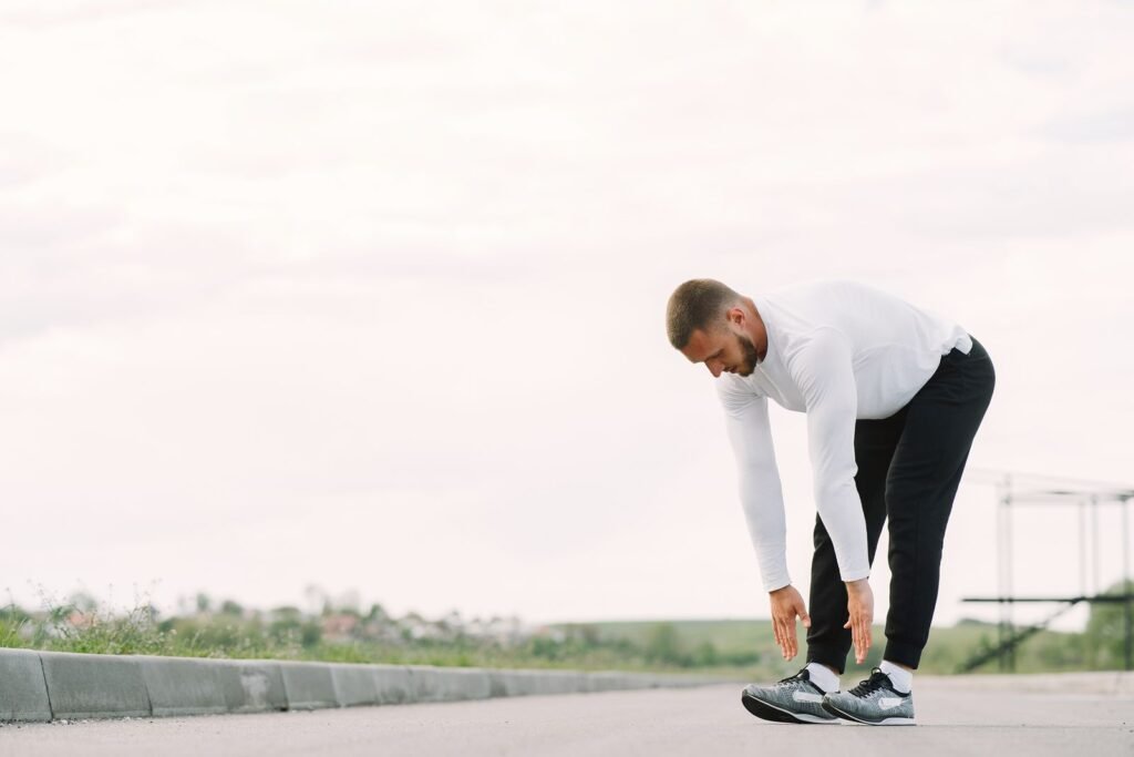Man stretching outdoors as part of a healthy routine