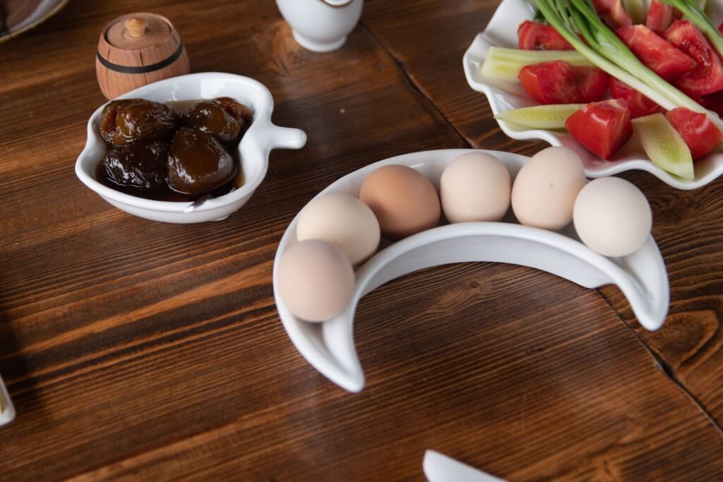 Breakfast table with fresh eggs and tomatoes