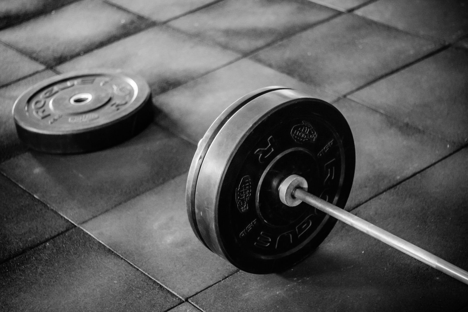 Loaded barbell resting on a gym floor