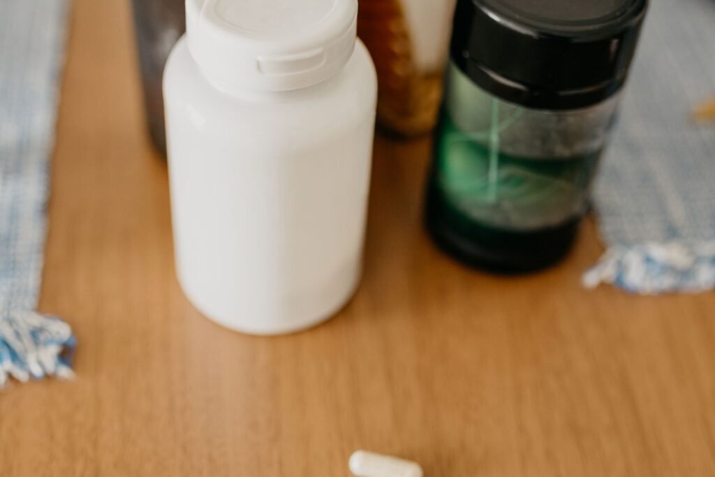 Assorted supplement bottles and capsules on a table