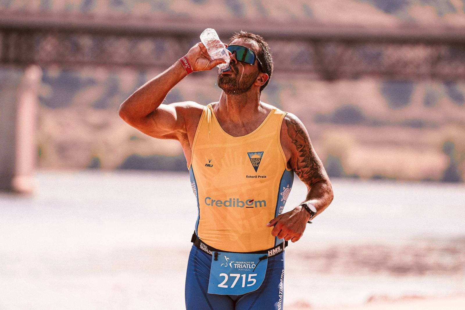 Male runner drinking water during a marathon
