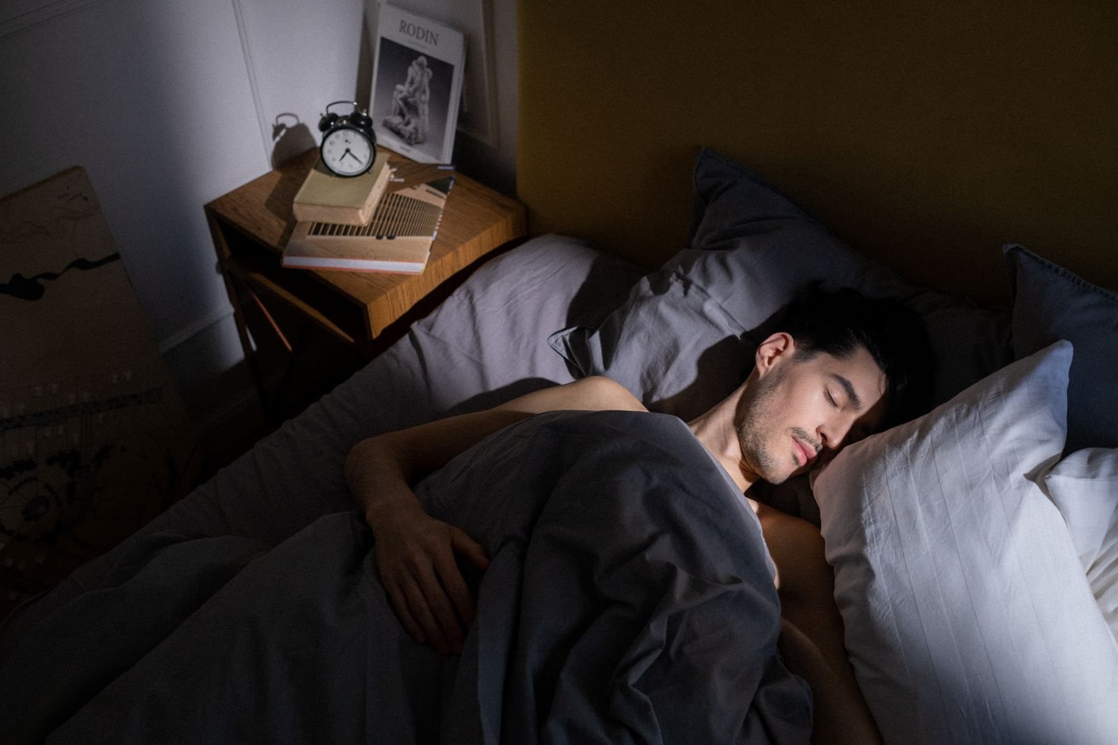Man asleep on his side in bed