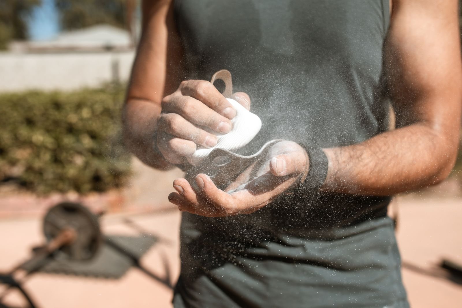 Man chalking his hands before a lift