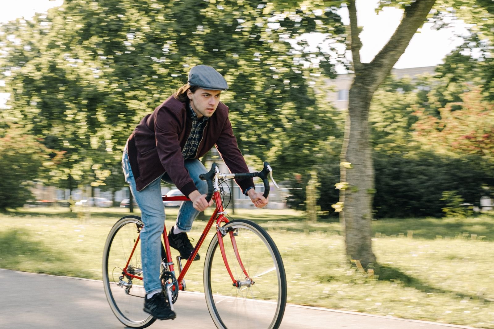 Man cycling at an easy pace on a park road