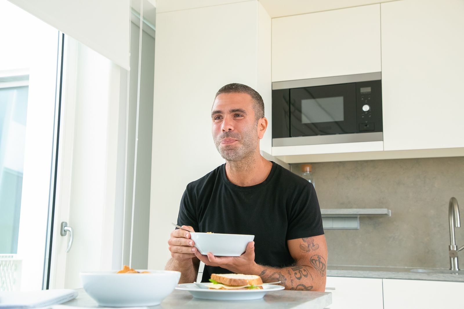 Man eating breakfast at his kitchen table