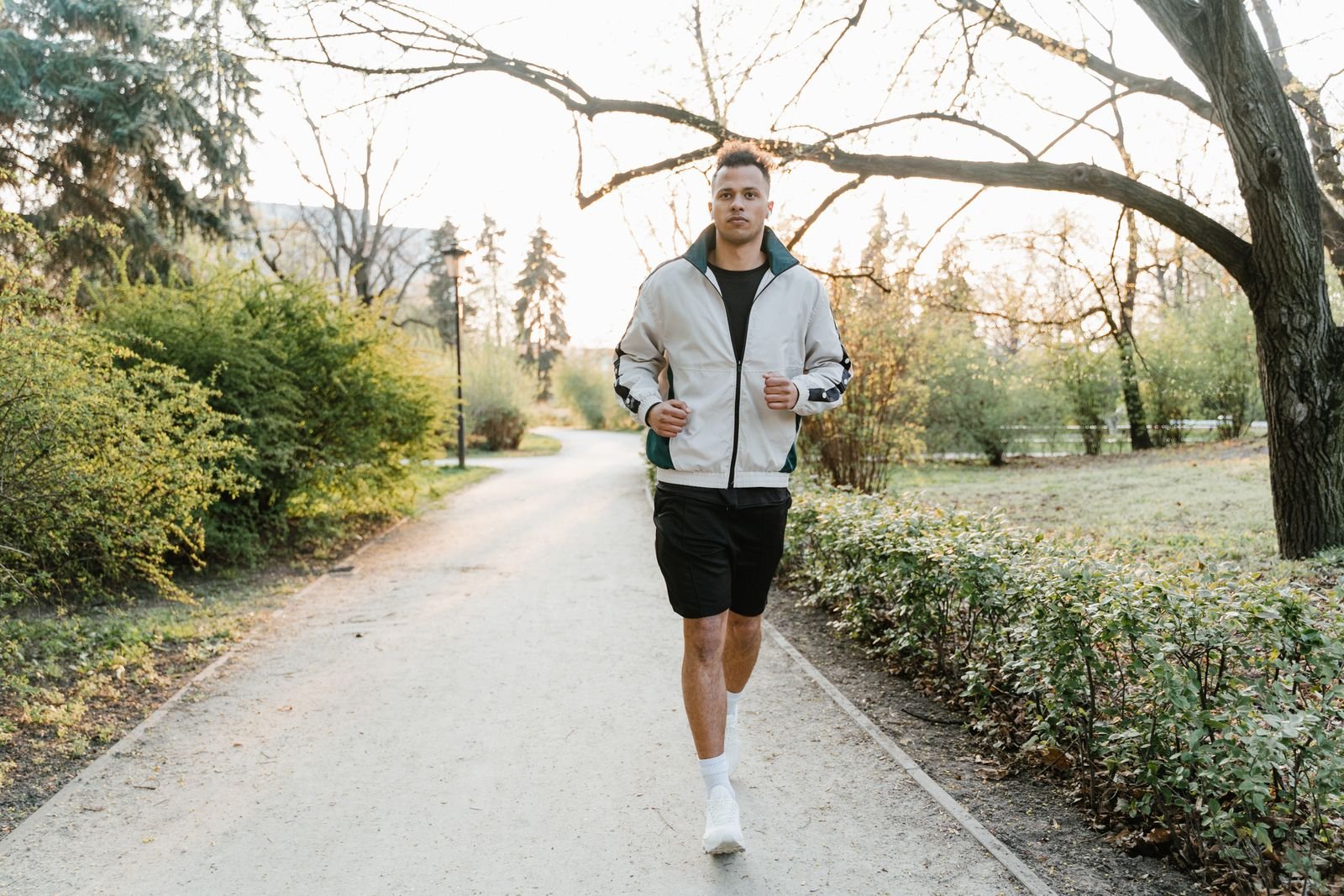 Man jogging along a tree lined path
