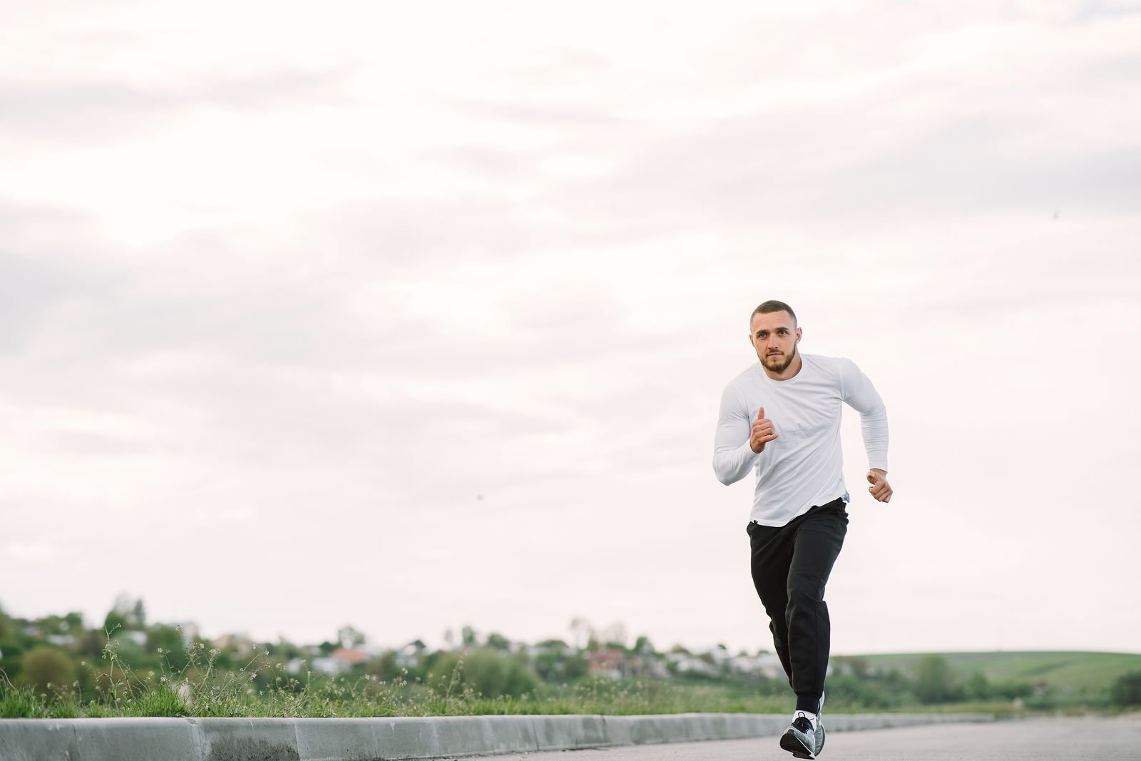 Man running along an open path outdoors