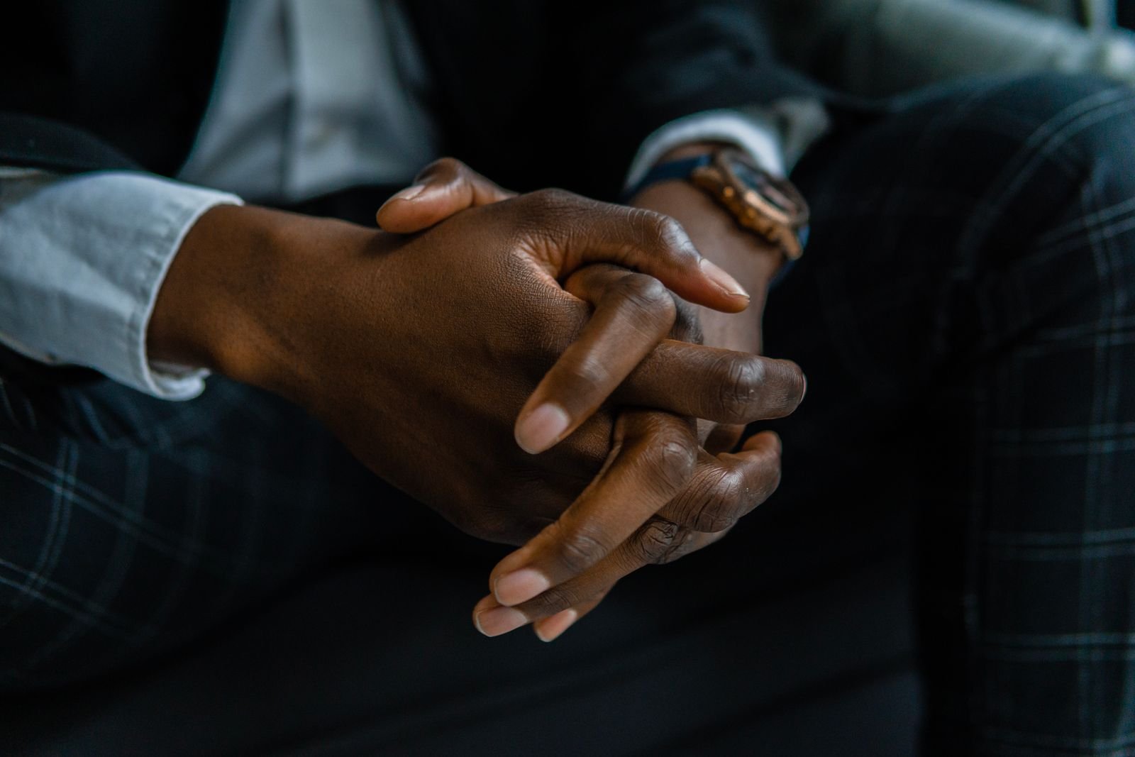 Man's hands clasped together