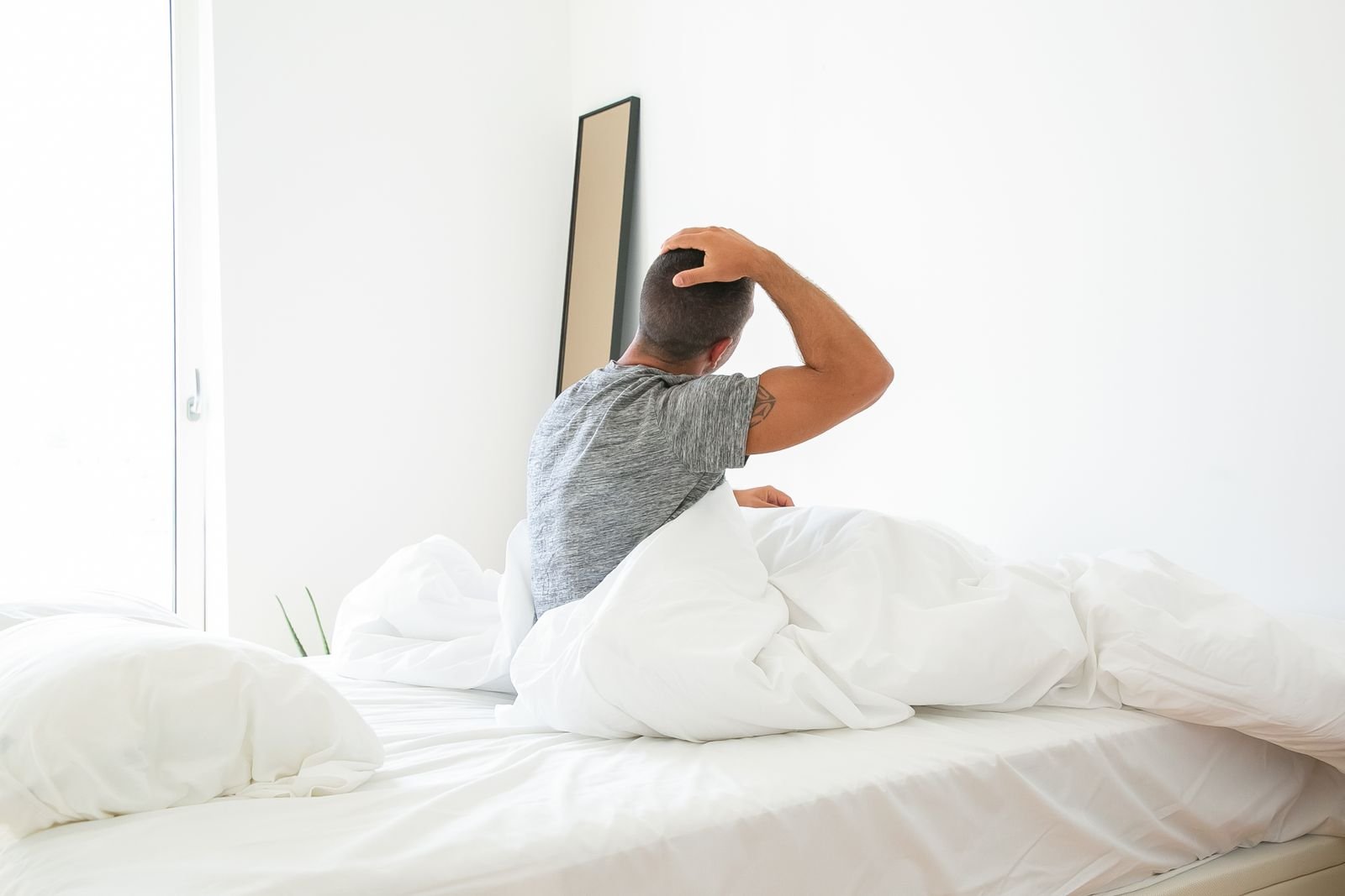 Man stretching as he wakes in the morning