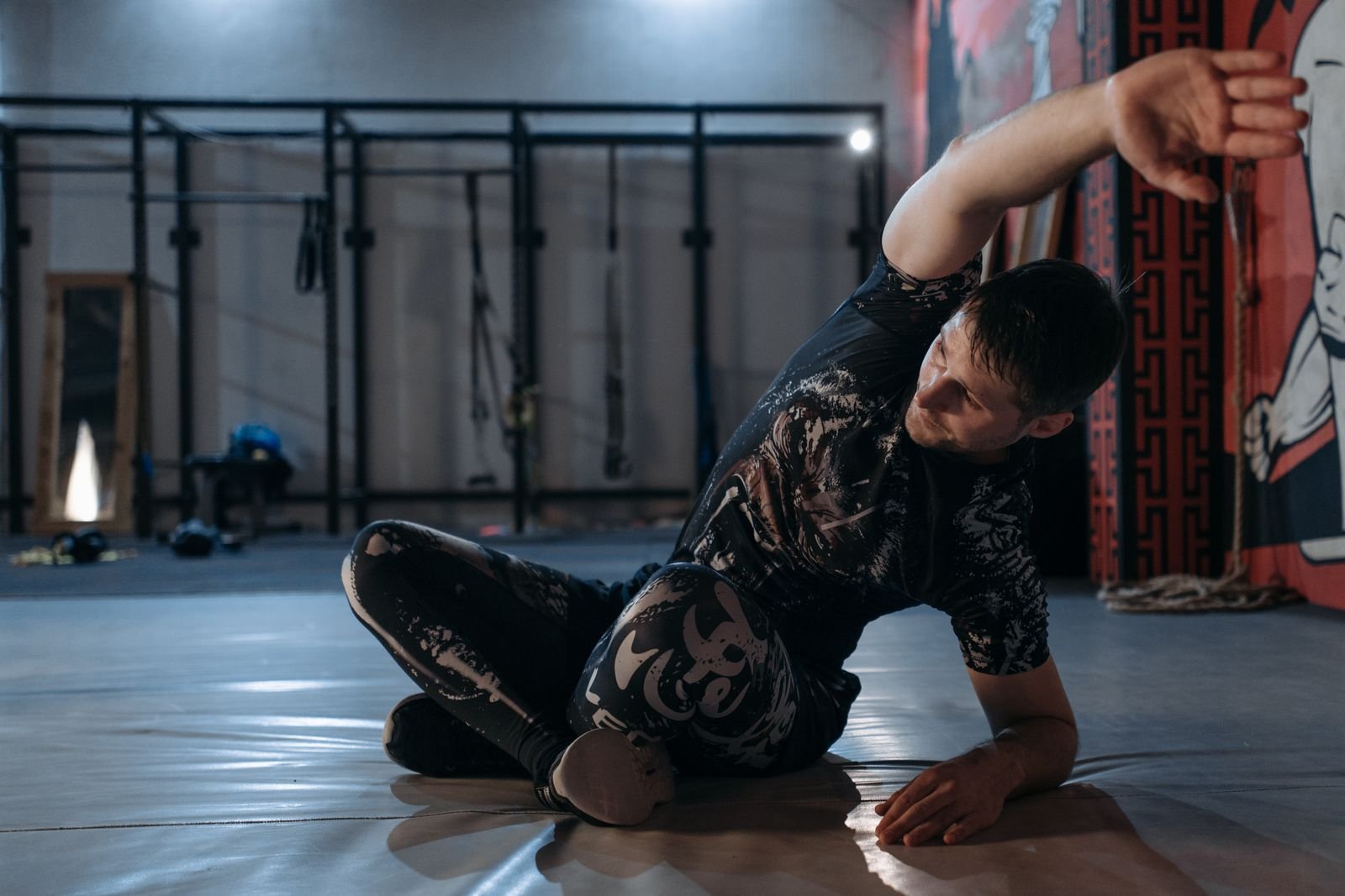 Man stretching on a gym floor before training