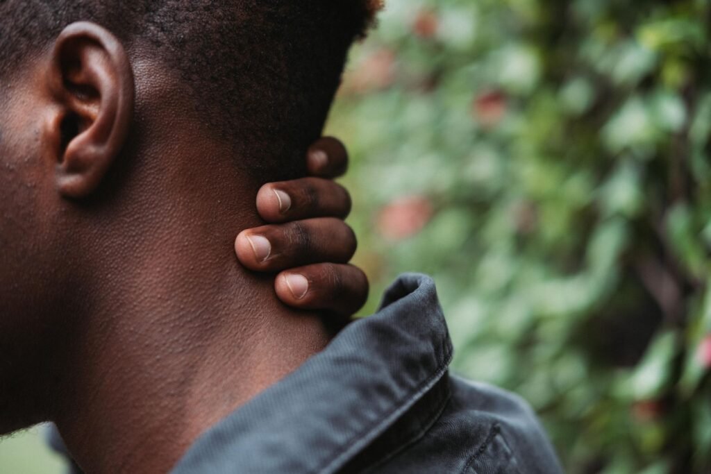 Man touching the side of his neck