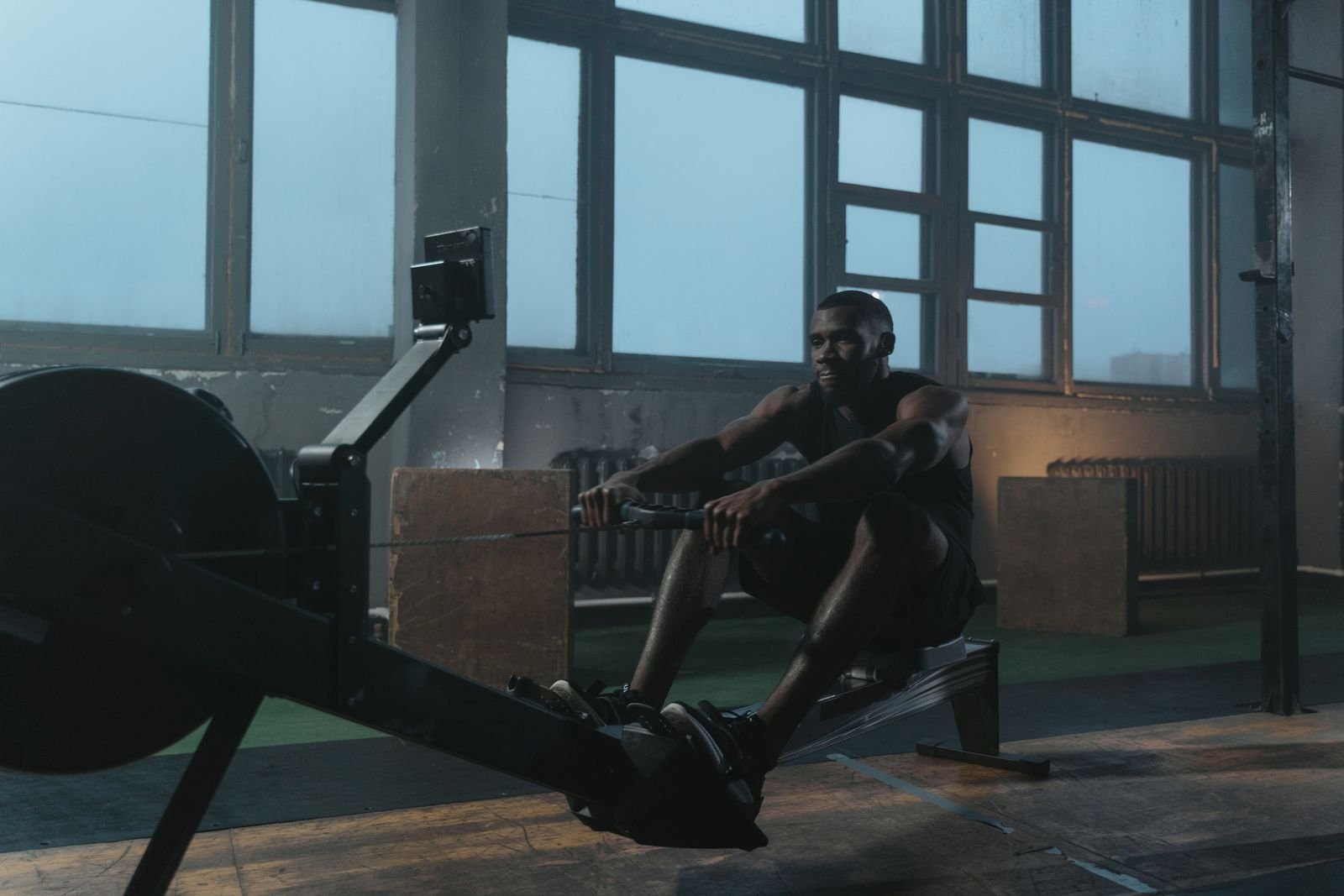 Man training hard on a rowing machine