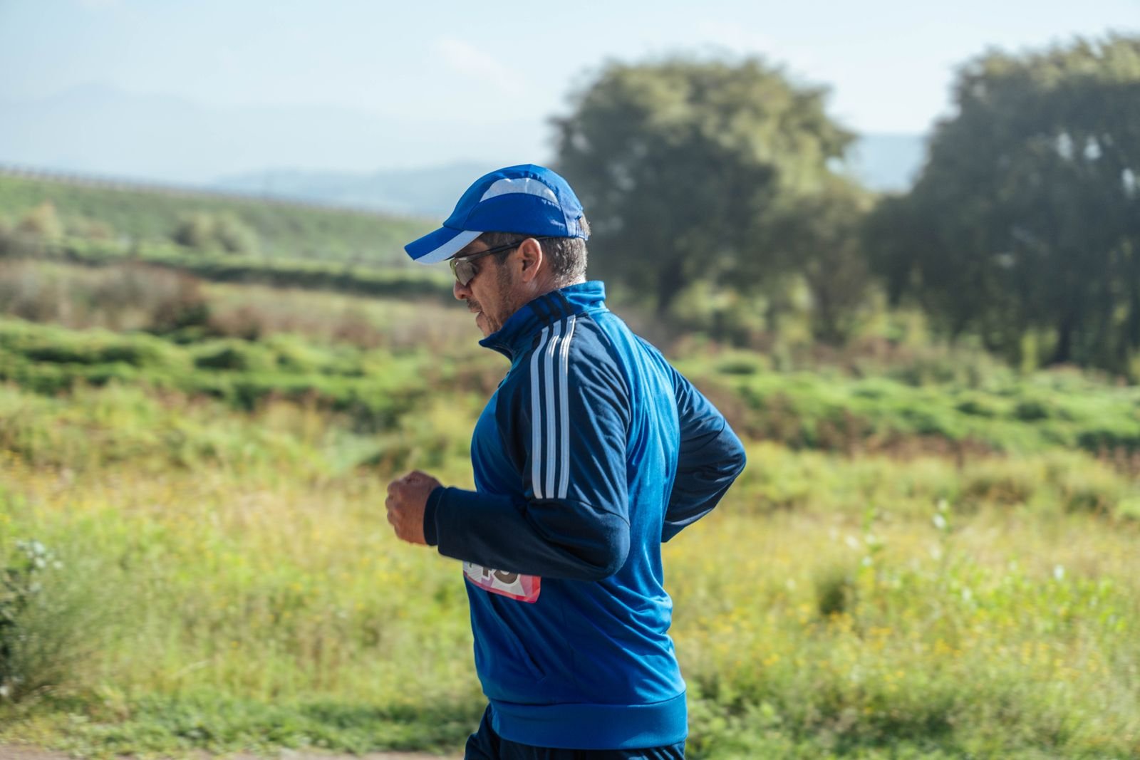 Middle-aged man jogging along a country path