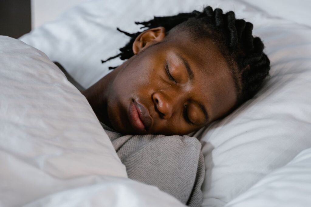 Young man sleeping peacefully in a cosy bed