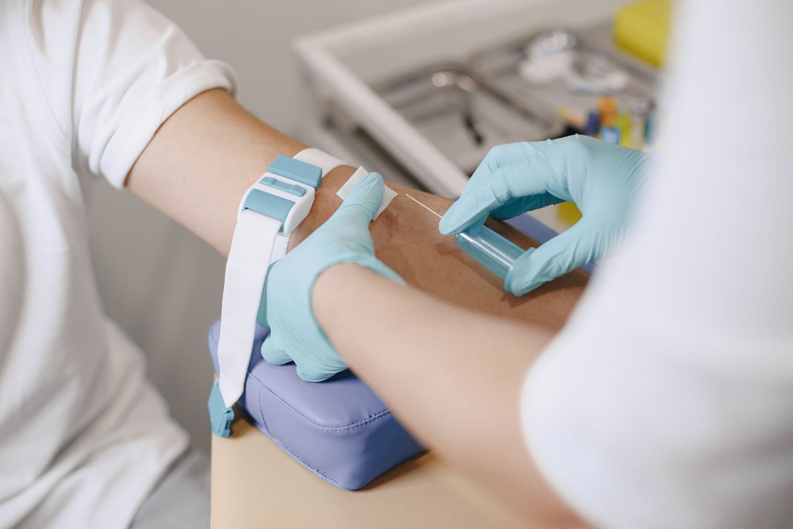 Nurse drawing a blood sample from a patient arm