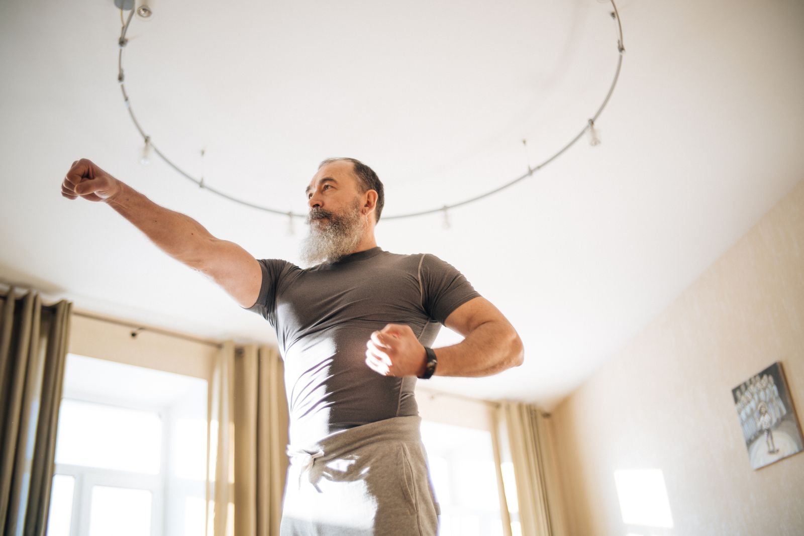 Older man doing a yoga stretch at home