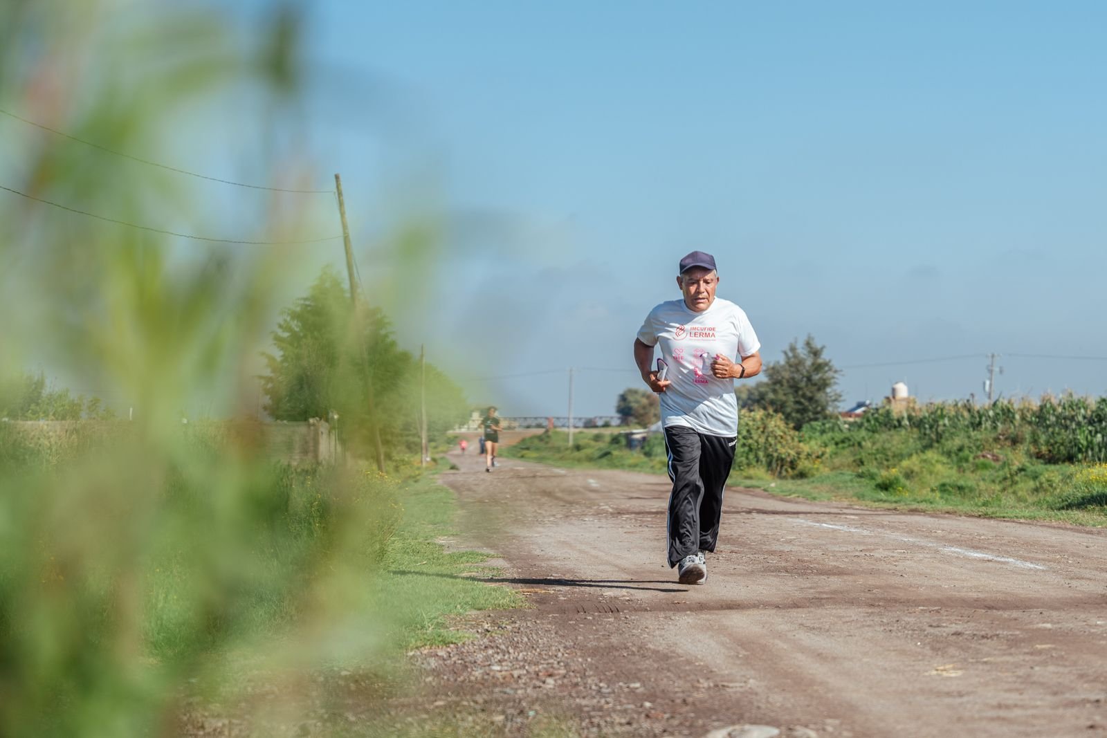 Older man jogging on a rural dirt road