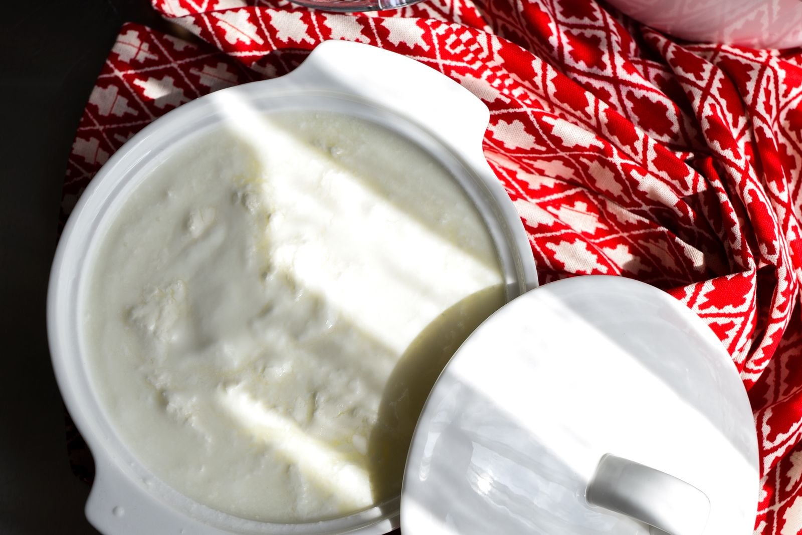 Open tub of plain yogurt