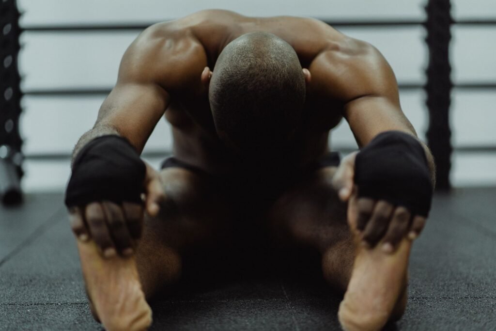 Man sitting on the gym floor after a hard workout