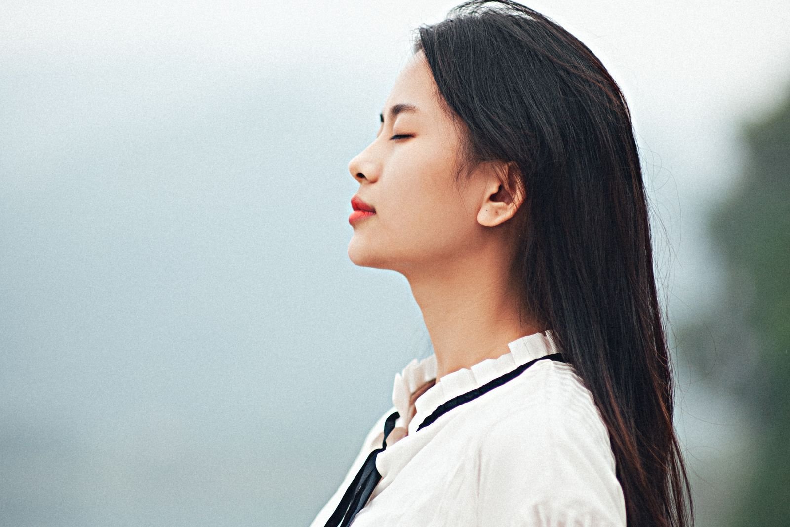 Person breathing calmly with eyes closed