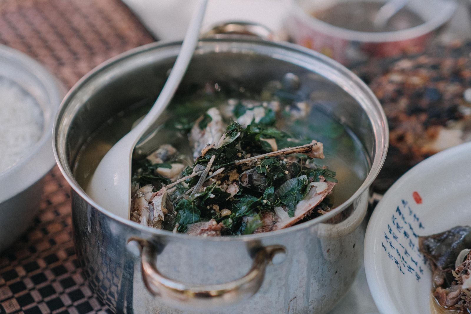 Pot of broth simmering on a stove