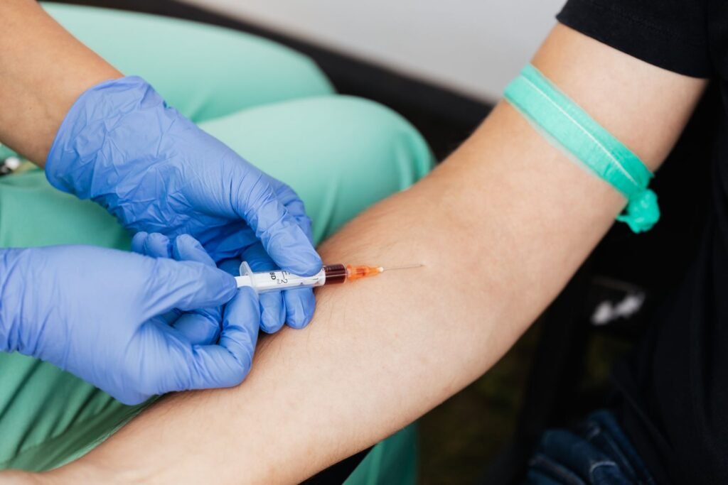 Healthcare worker drawing blood from a patient's arm