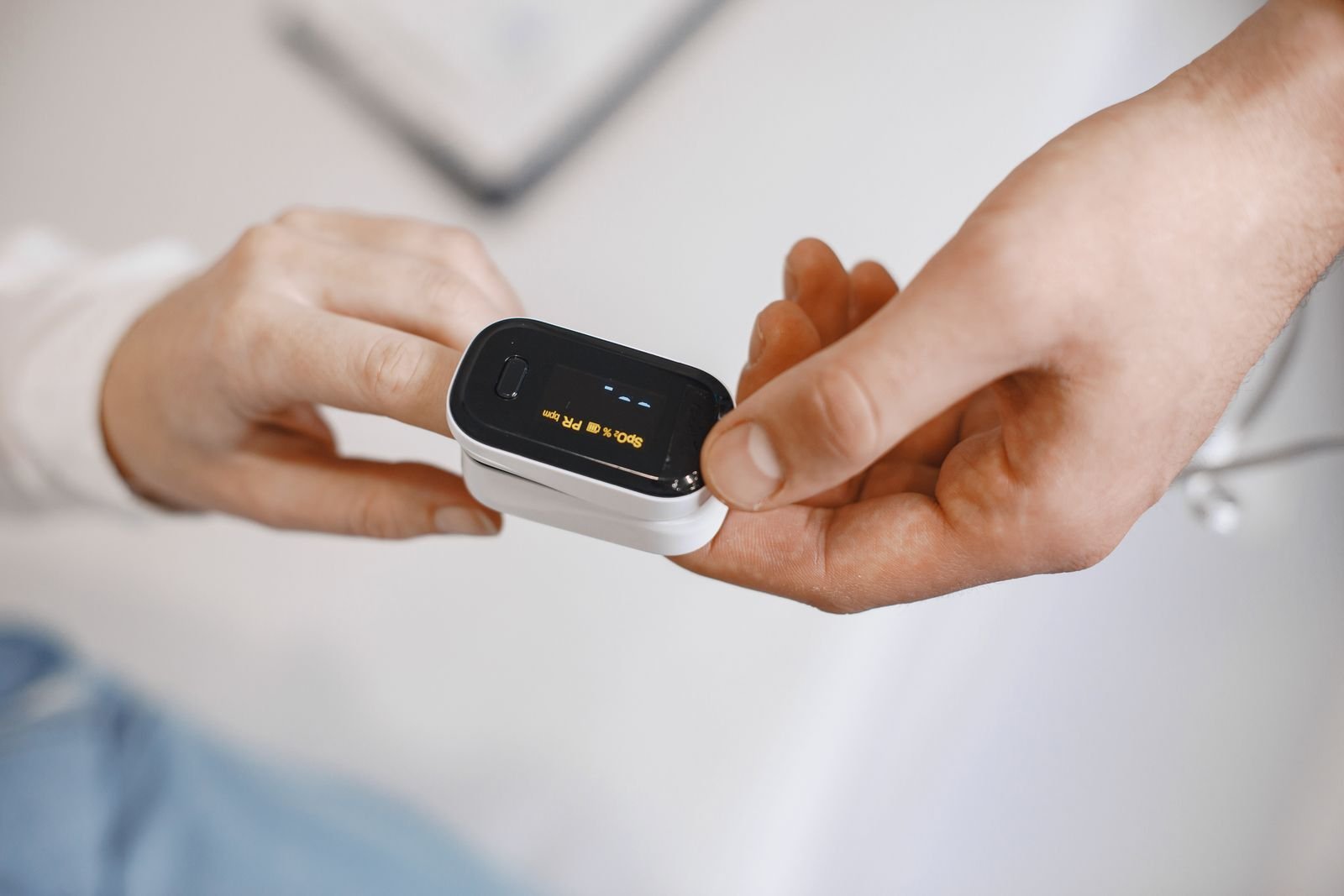 Pulse oximeter clipped to a fingertip