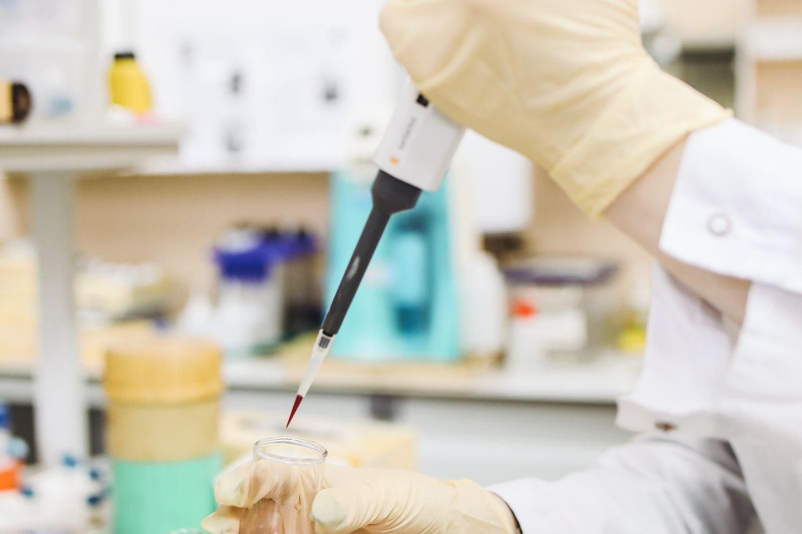 Researcher pipetting a sample in a laboratory