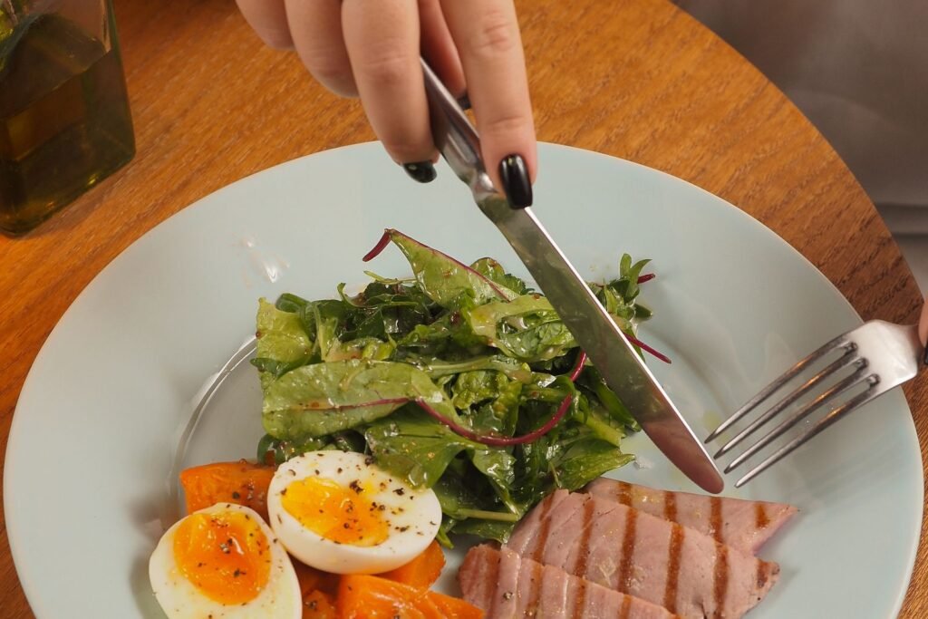 Balanced plate of salad, boiled egg and tuna