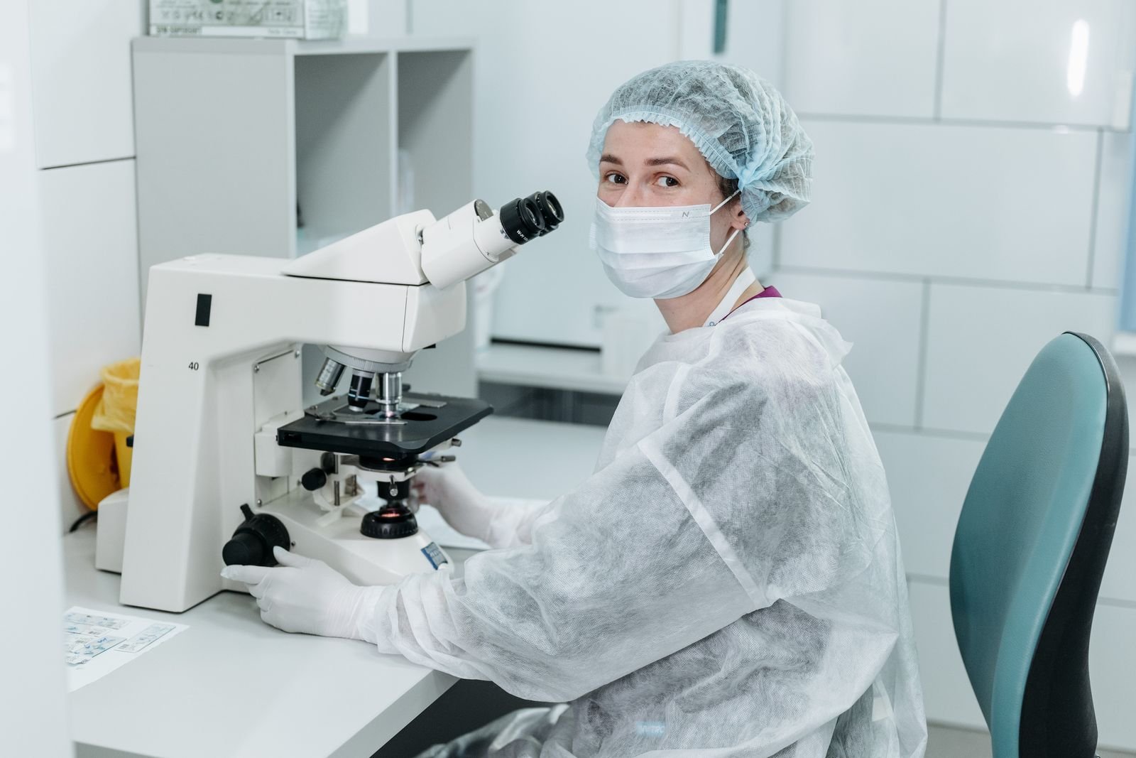 Scientist examining a sample under a microscope