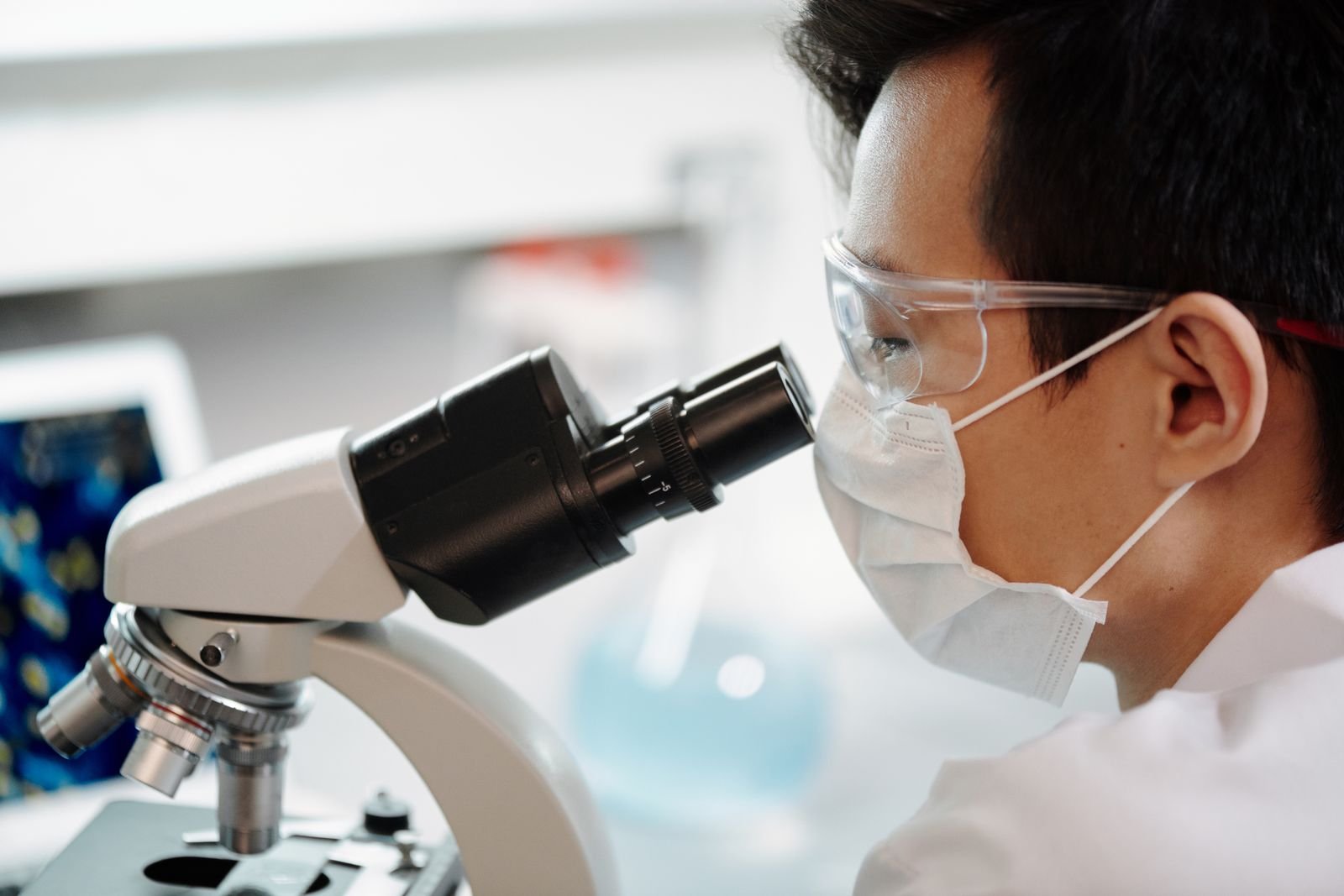 Scientist examining samples through a microscope