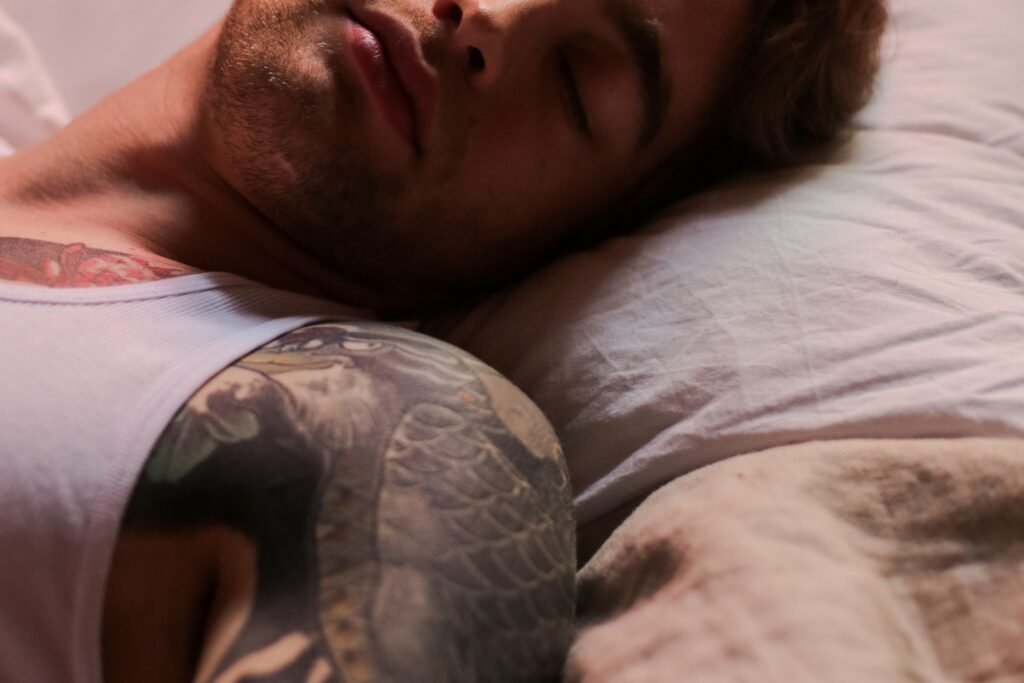 Man resting in bed, recovering after training