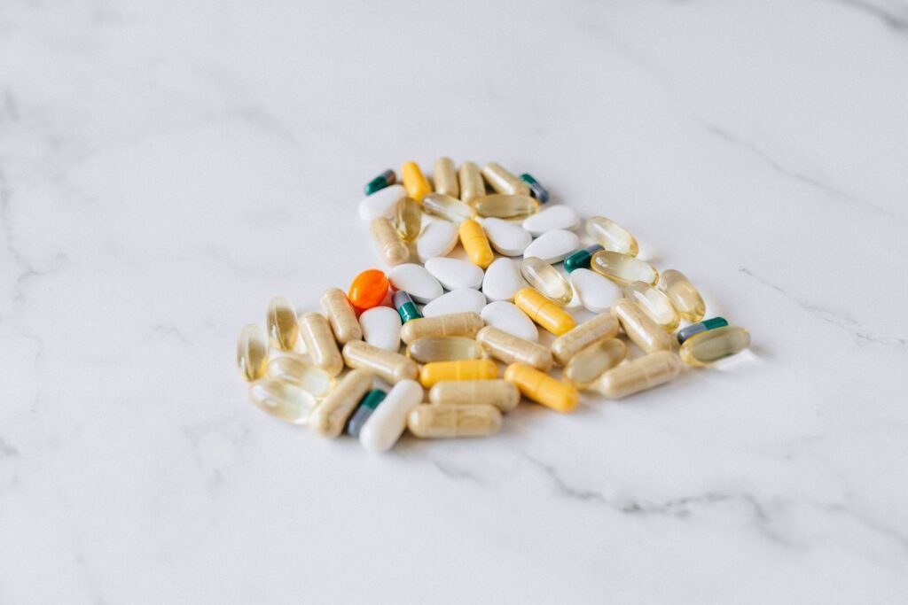Assorted supplement capsules on a marble surface