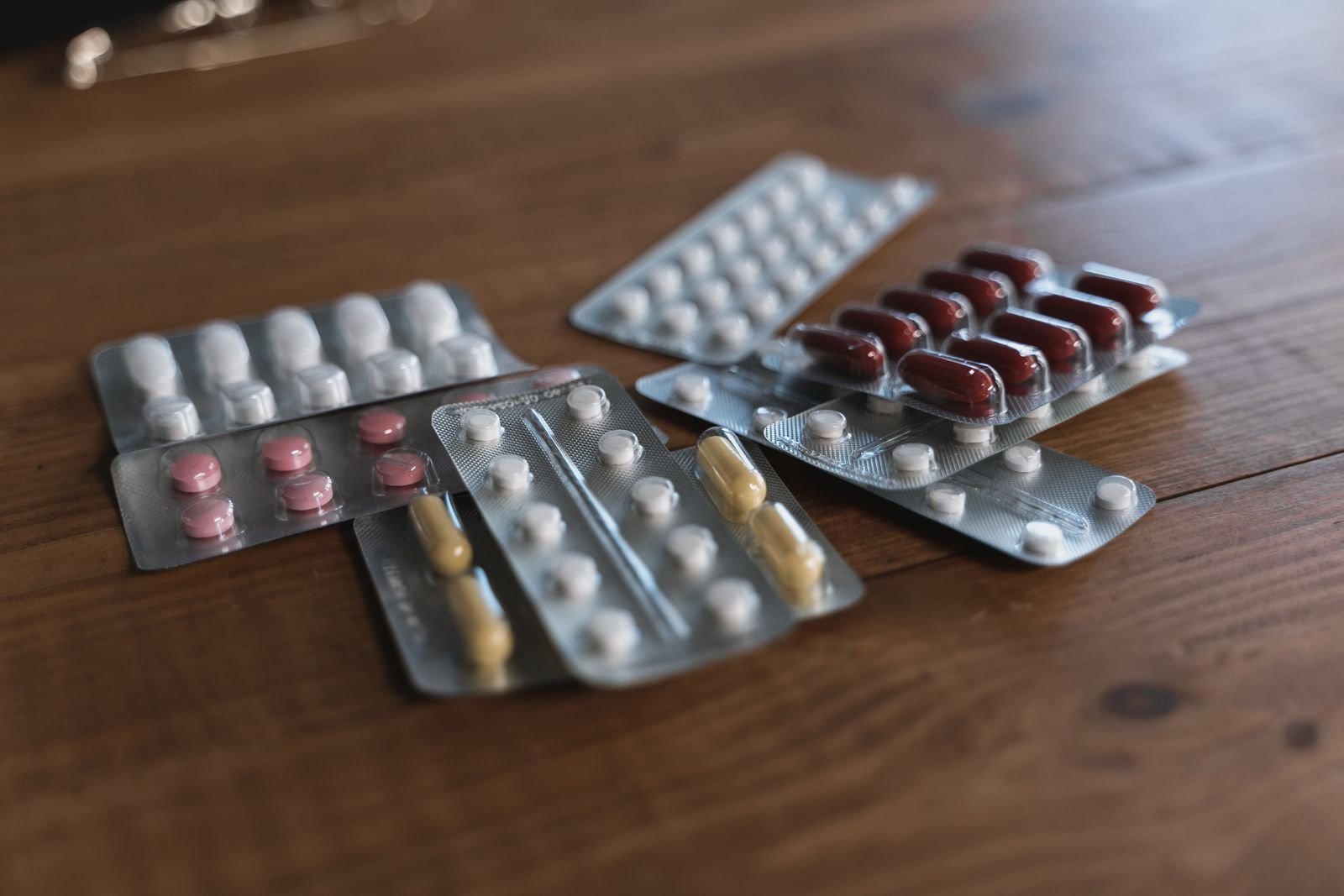 Tablets in blister packs on a wooden table