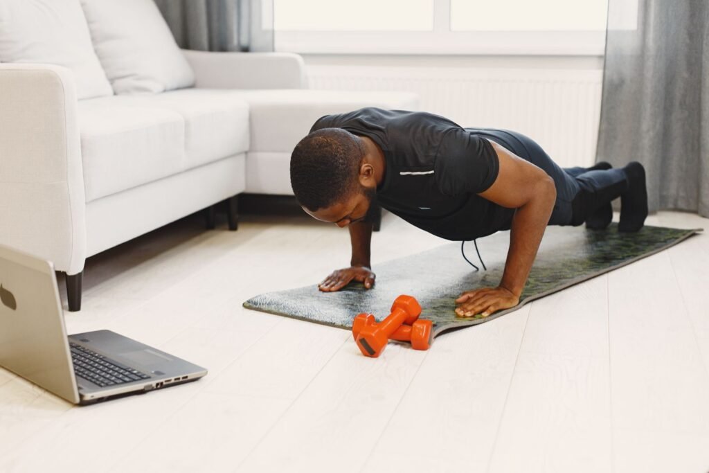 Man doing push-ups on a mat in a living room