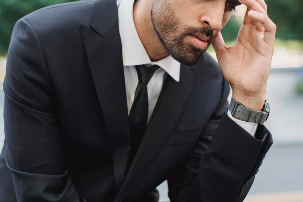 Calm man in a suit thinking in an outdoor setting
