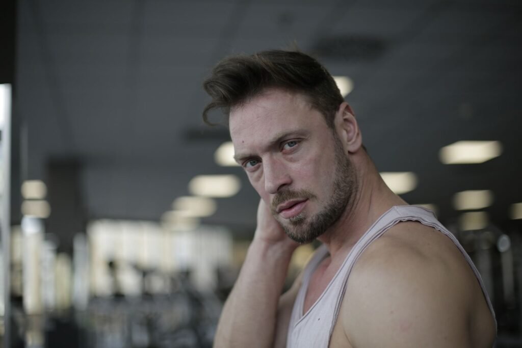 Man in a gym looking thoughtful
