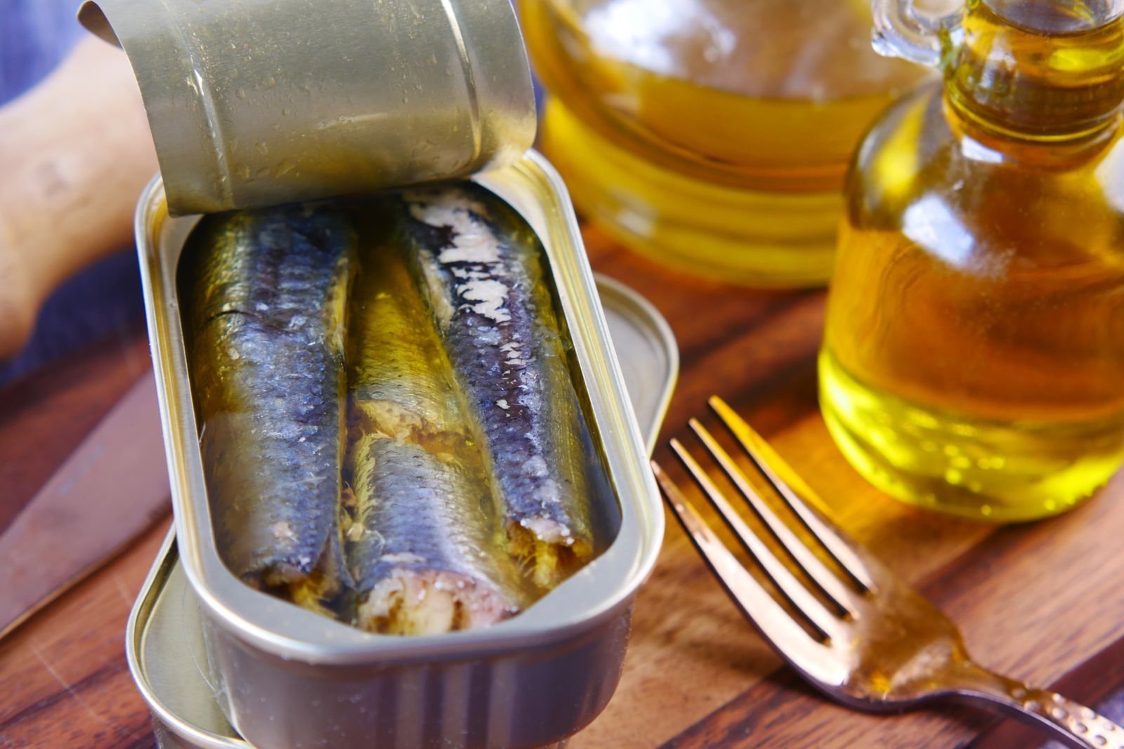 Tin of sardines in olive oil with a fork