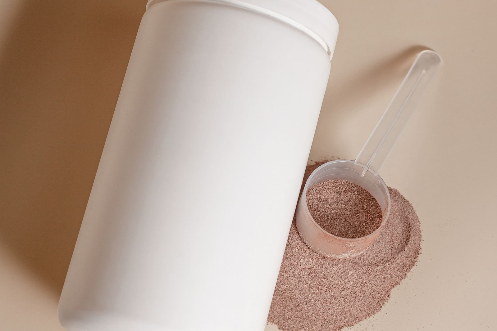Tub of powdered supplement on a worktop