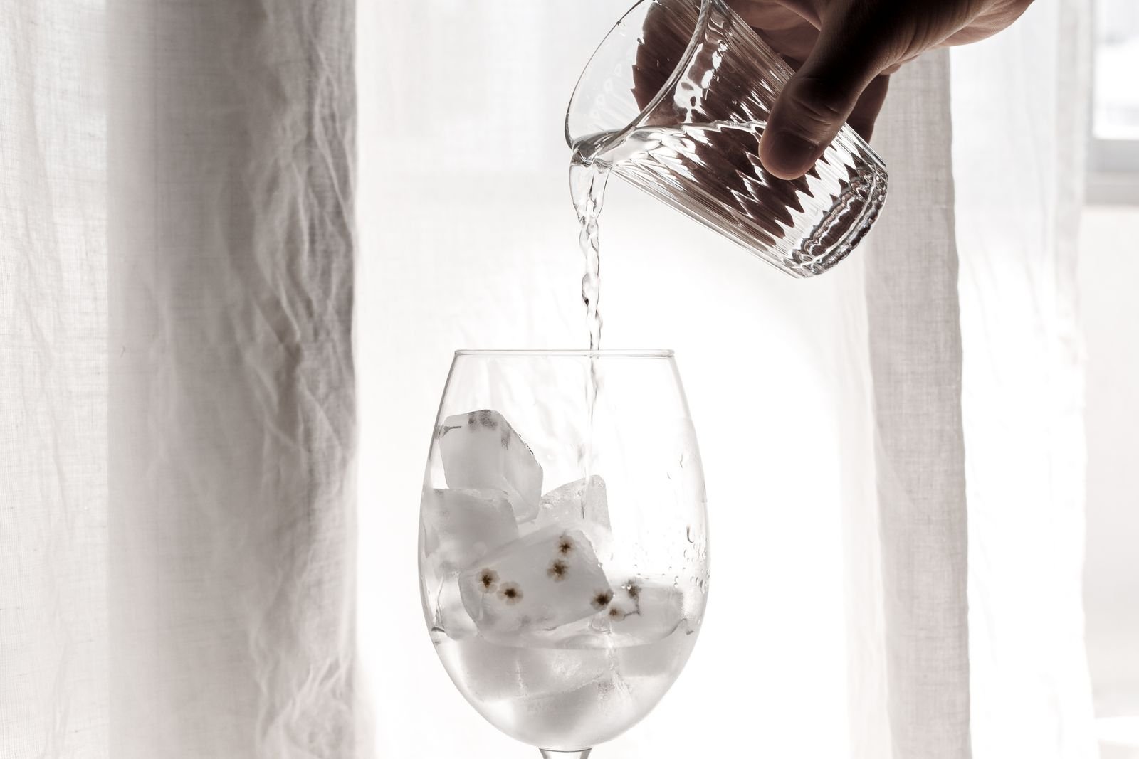 Water being poured into a glass in the evening
