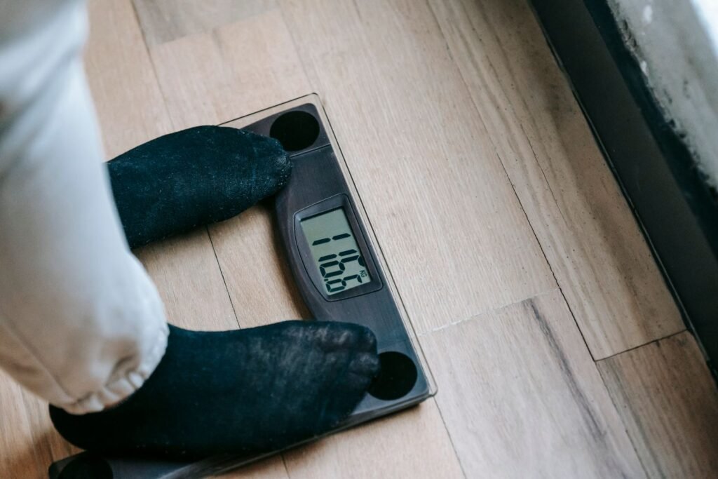 Feet on a digital bathroom scale, illustrating a weight loss plateau