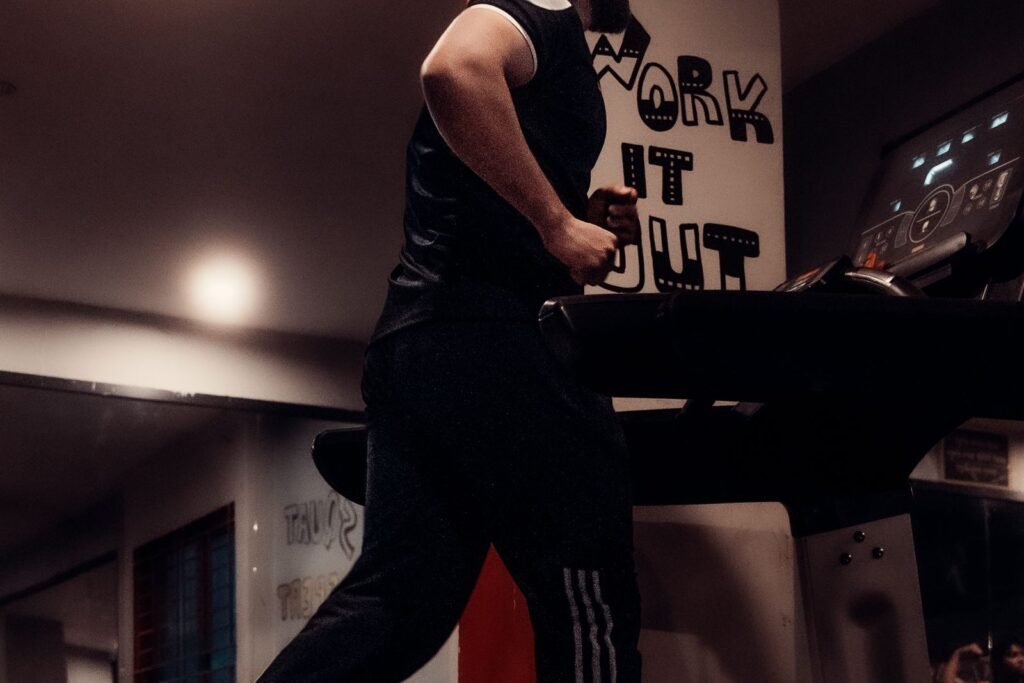 Man running at a steady pace on a treadmill