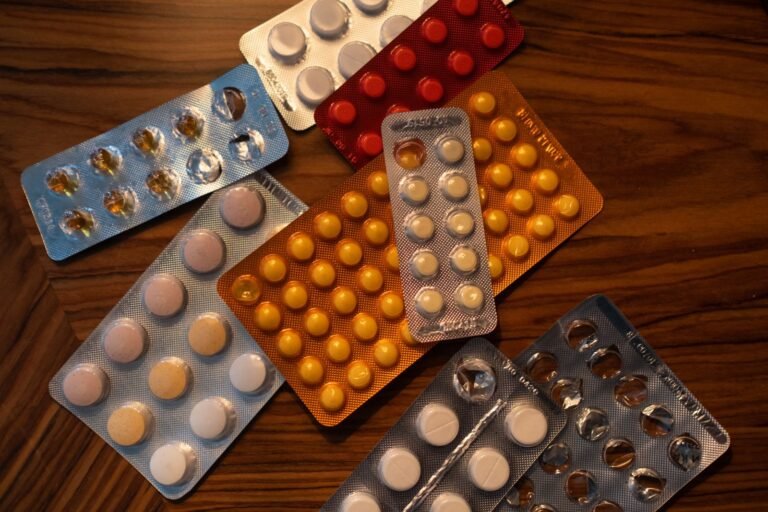 Blister packs of tablets on a wooden table